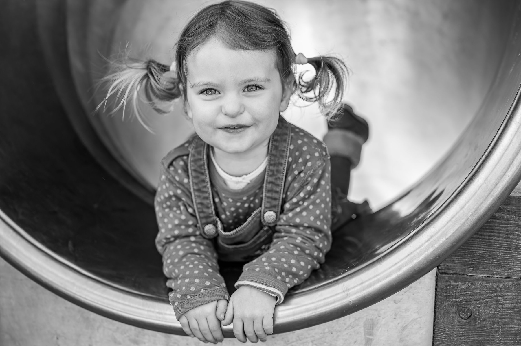 Black and white portrait of a child blowing bubbles