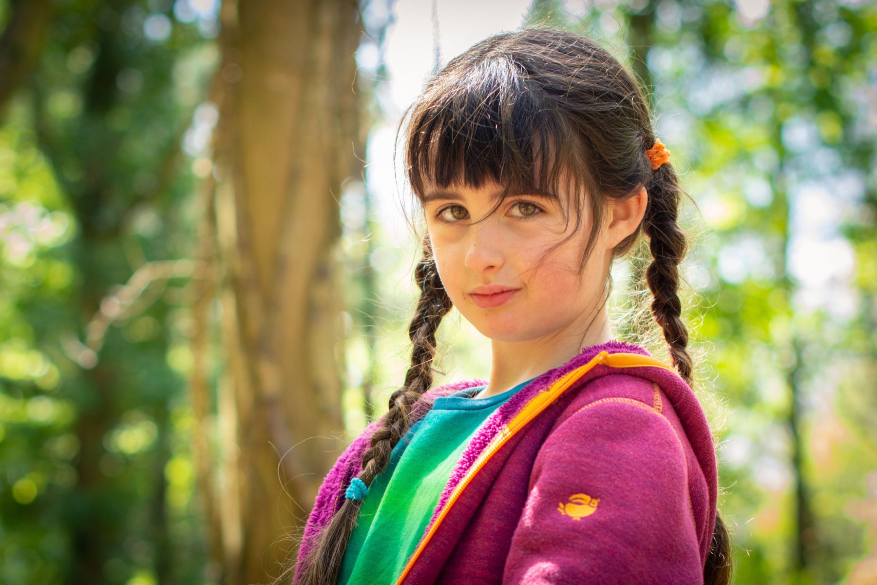 Child photographed in woodland during an outdoor portrait session