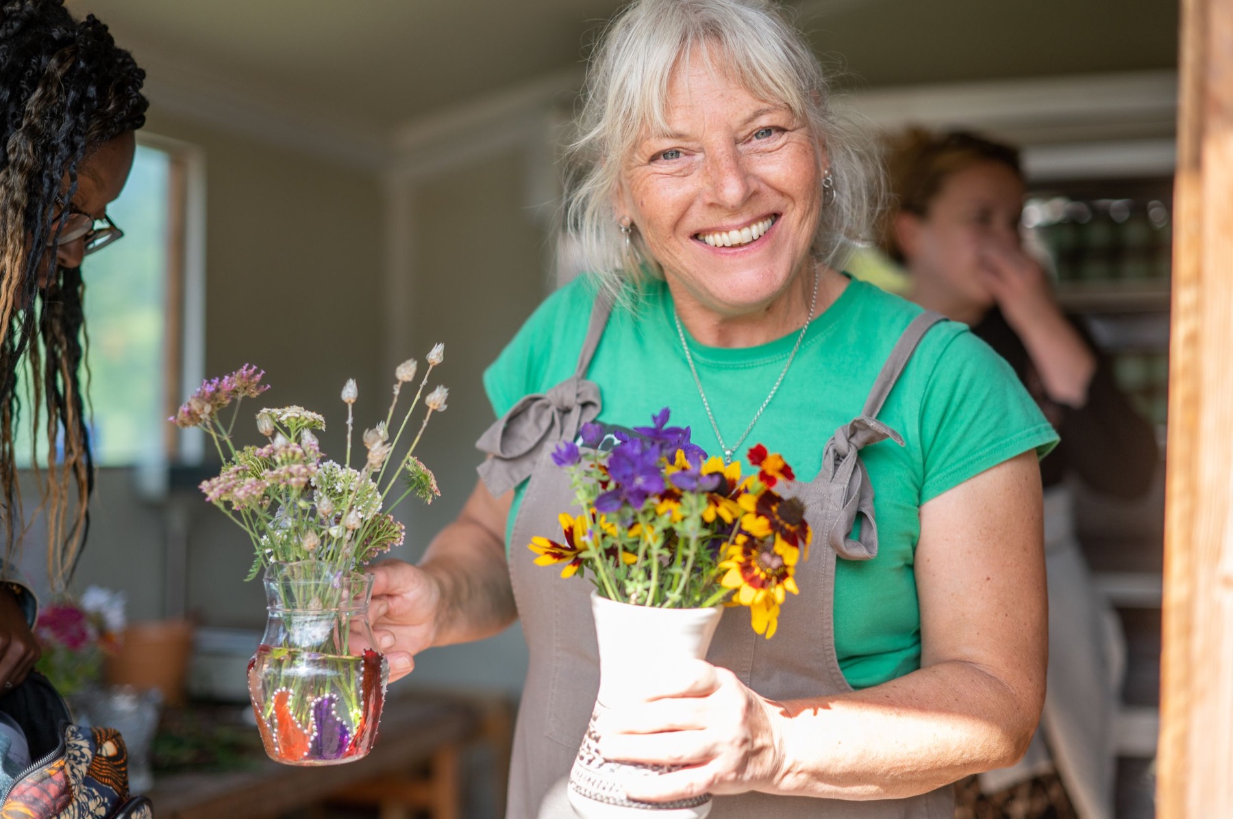 Smiling guest arranging flowers at a community event