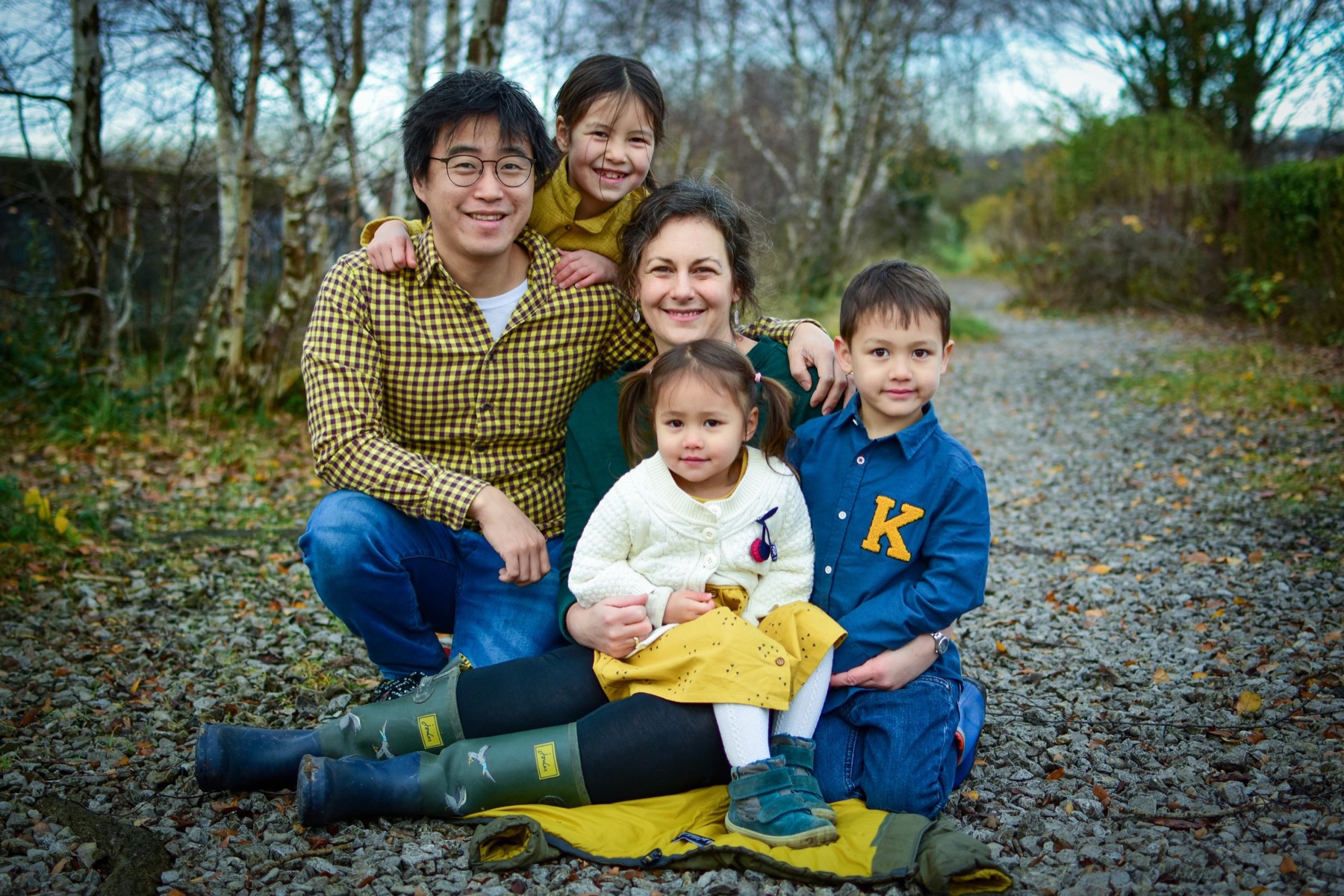 Family sitting together on a woodland path