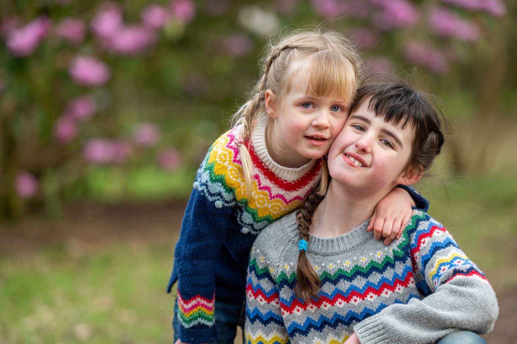 Two children cuddling in a natural outdoor portrait